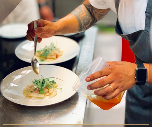 Chef Karim Schumann preparing dishes for an event catering client